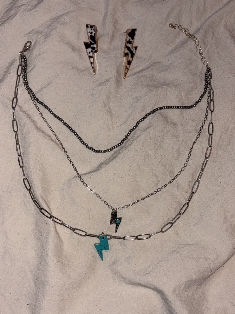 Layered Silver Lightning Bolt and cow print lightning bolt earrings